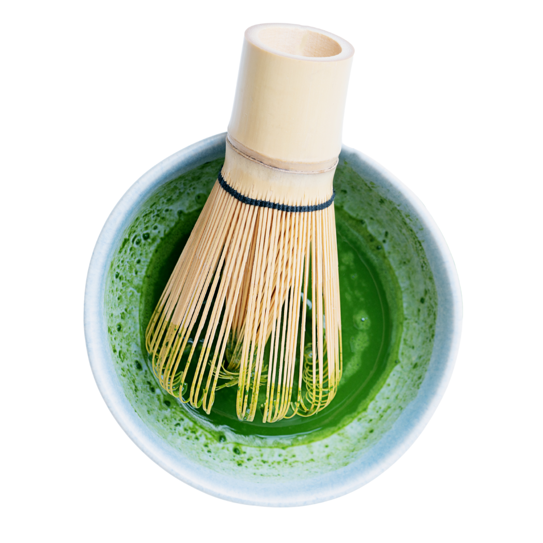 Bamboo whisk in a bowl of green matcha tea on a white background